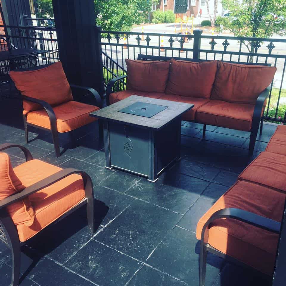 Outdoor seating with orange cushions at Dublin Square in Lansing.