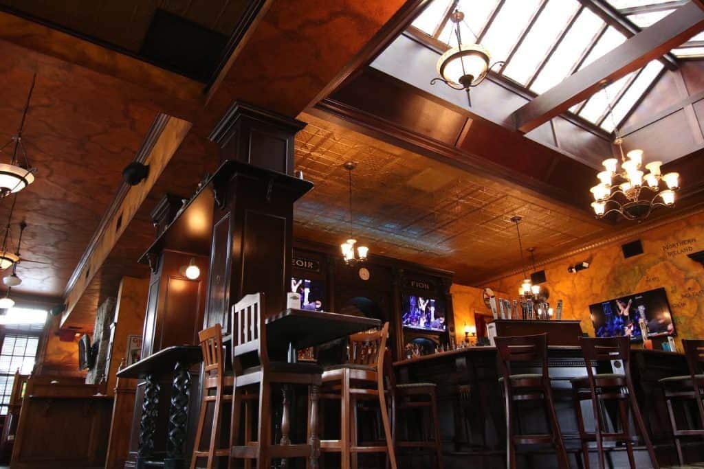Cozy Irish pub interior with wooden decor and bar seating at Dublin Square.
