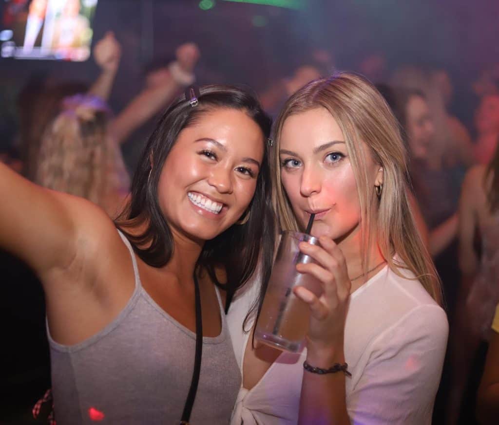 Two women enjoying drinks at Dublin Square bar in Lansing.