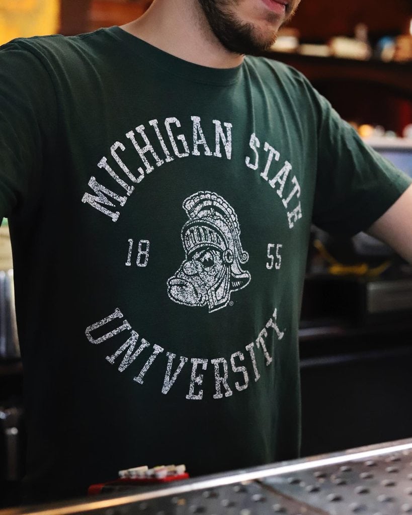 Person wearing Michigan State University T-shirt at Dublin Square.