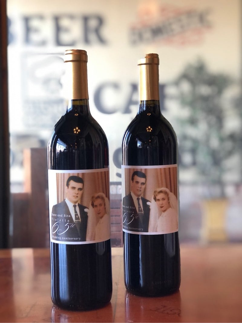 Vintage wine bottles with personalized labels celebrating Dusty's Cellar anniversary. Perfect for wi.