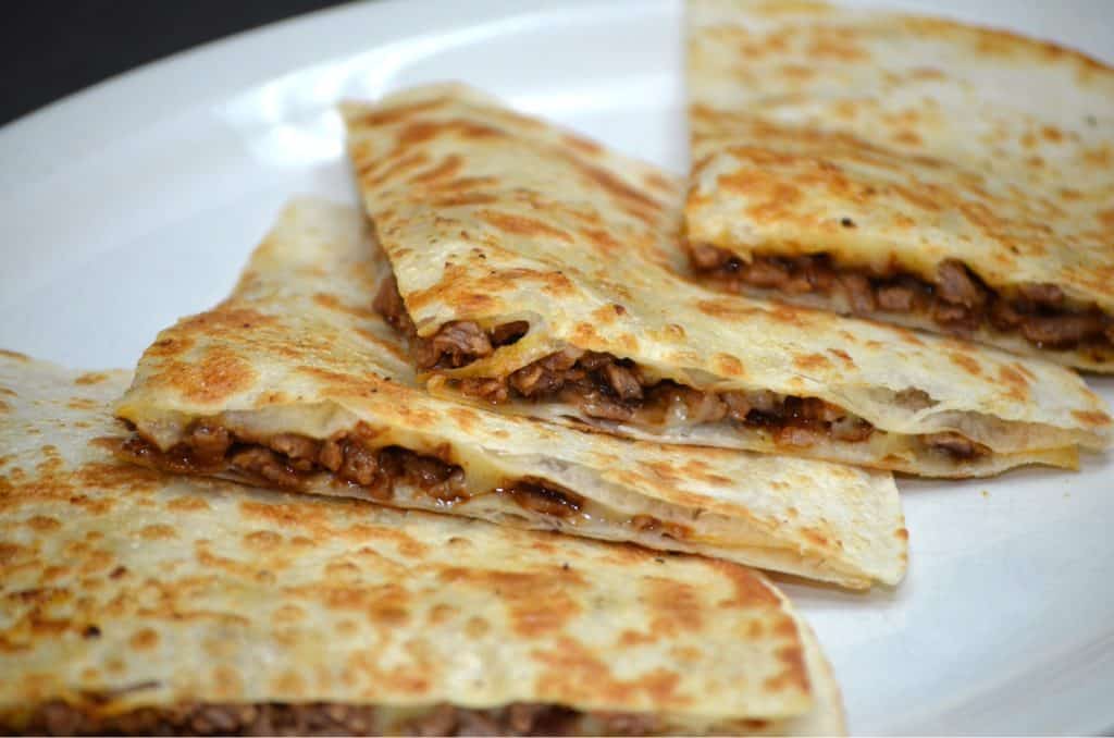 Delicious cheese and beef quesadilla, perfect for catering events.