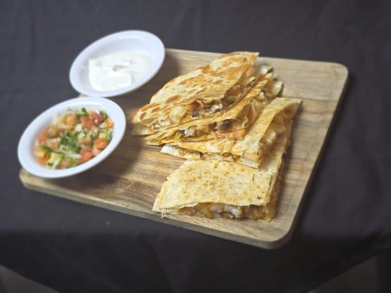 Authentic Mexican tacos served with salsa and sour cream at El Mesquite.