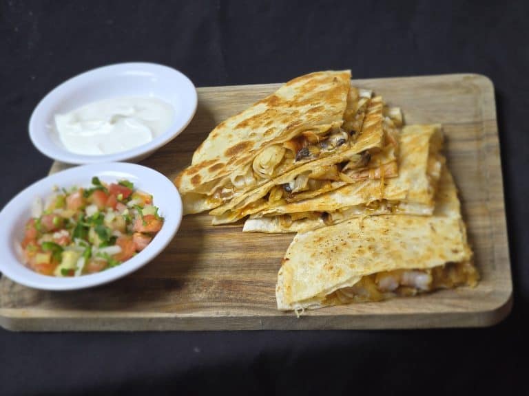 Delicious tacos served with sour cream and salsa at El Mesquite Mexican Bar & Grill.