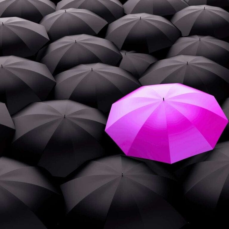 Bright pink umbrella standing out among black umbrellas – concept image representing unique branding, marketing differentiation, and standing out from competitors.