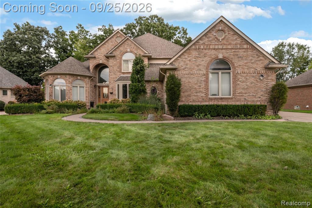Brick exterior with arched windows, gabled roofline, and curved entryway