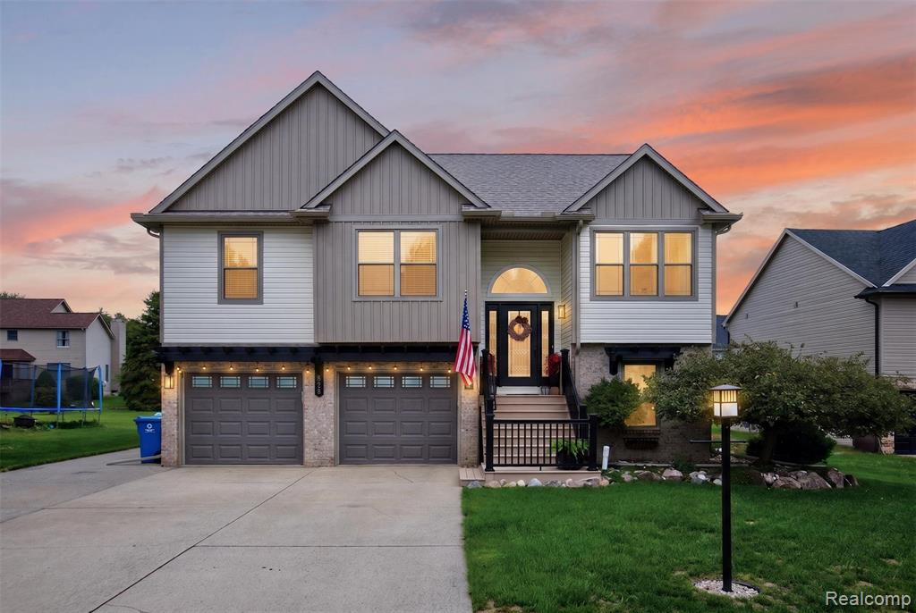 Multi-level facade with mixed siding and stone accents
