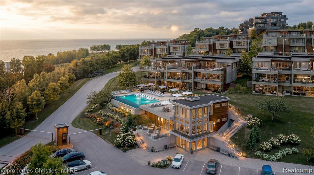 Rising above Little Traverse Bay, The Summit Over Bay Harbor offers a rare opportunity to create a bespoke waterfront residence in one of Northern Michigan’s most prestigious resort settings. Designed for those who value elevated living, privacy, and unforgettable surroundings, each residence captures sweeping water views and dramatic sunsets from multiple levels.This expansive offering features approximately 5,586 square feet of interior living space, complemented by a 1,139 square foot rooftop terrace designed for entertaining, relaxation, and evening gatherings overlooking Lake Michigan. An additional 720 square feet of unfinished lower-level space provides flexibility for storage or future customization, bringing the total square footage to approximately 7,445 square feet. Floor-to-ceiling windows flood the interiors with natural light and frame the bay as a living work of art. The open main living level is ideal for hosting, anchored by a gourmet kitchen with premium appliances, generous island, fireplace, wet bar, and seamless indoor-outdoor flow.The primary suite is a serene retreat with panoramic water views, private patio access, a spacious walk-in closet, and spa-inspired bath. Multiple en-suite bedrooms, each with private outdoor access, provide exceptional comfort and privacy for family and guests. A detached guest house and four-car garage further enhance the residence, while elevator access connects each level with ease.Residences at The Summit Over Bay Harbor are offered as custom build opportunities, allowing buyers to select architectural details, interior finishes, and premium upgrades tailored to their lifestyle.Located across from The Cliffs at Bay Harbor and minutes from Petoskey, Charlevoix, Boyne City, and Harbor Springs, this is Northern Michigan luxury living at its finest.