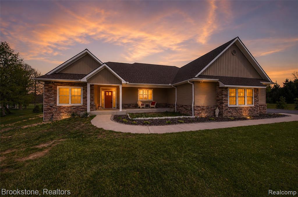 Two complete homes, one address! Direct lake frontage on nearly 10 acres. Built in 2023.What makes this property unlike anything else in Lapeer County isn't the acreage, the lake frontage, or even the 2023 construction - it's the way it was designed to accommodate the full arc of a family's life under one roof. The lower level is a complete, self-contained residence in every sense! Its own private entrance, garage, its own full kitchen, bedrooms, and bath, with a walk-out that opens directly to the water. Guests arrive with independence. The arrangement is thoughtful, not makeshift, and the separation of space is genuine. Above, the main home moves the way a well-designed home should. Light floods through oversized windows, the kitchen opens wide into the living spaces, and the primary suite sits quietly apart from the rest. Whole-home generator installed, and a 4-car garage totallying 1700 square feet. Over 3800 square feet across both finished levels, finished in 2023, with the kind of quality that holds. Nearly 10 private acres along Rood Lake, a balcony, a patio, and a porch. Come see this unique property before it's gone!