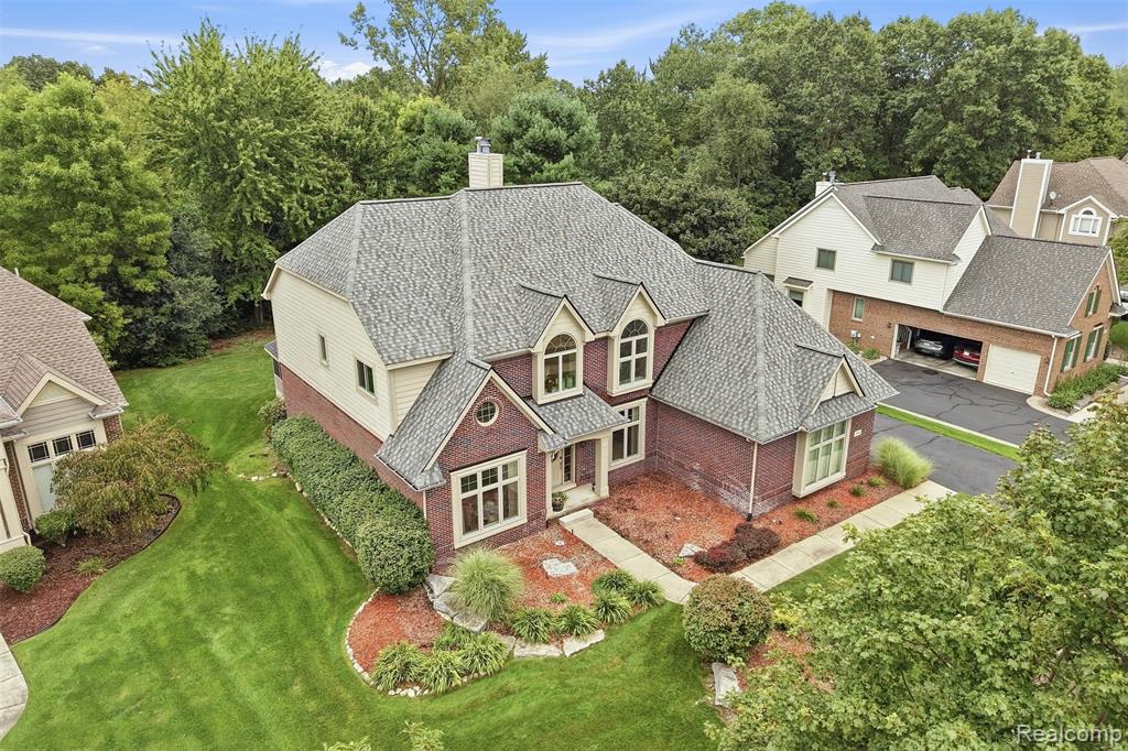 Brick and siding exterior with multiple gables and dormer windows