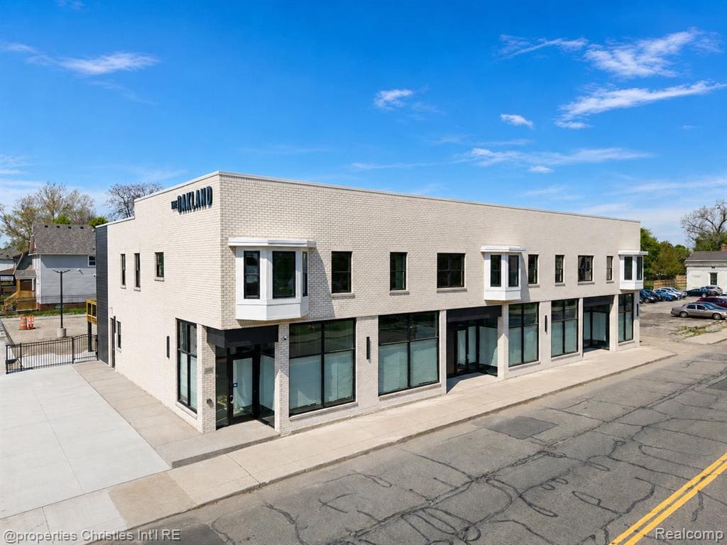 Modern commercial building with a light-colored brick facade