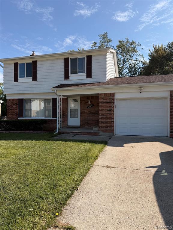 Brick and siding exterior with a two-car garage
