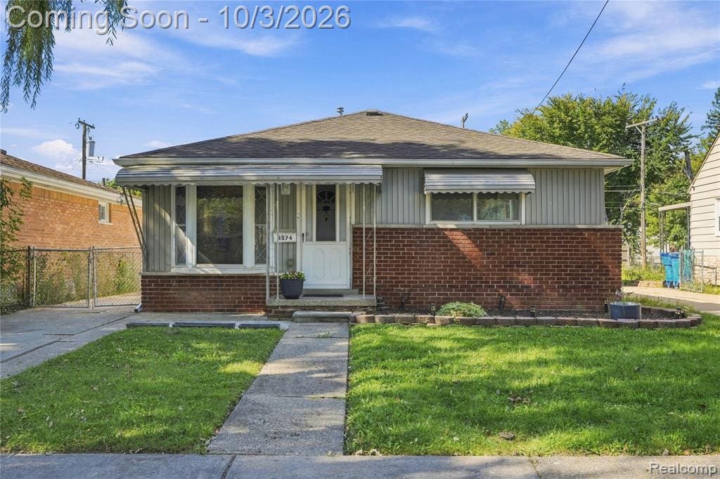 Front of the home: a brick and vinyl ranch with a covered front step and a bay window.
