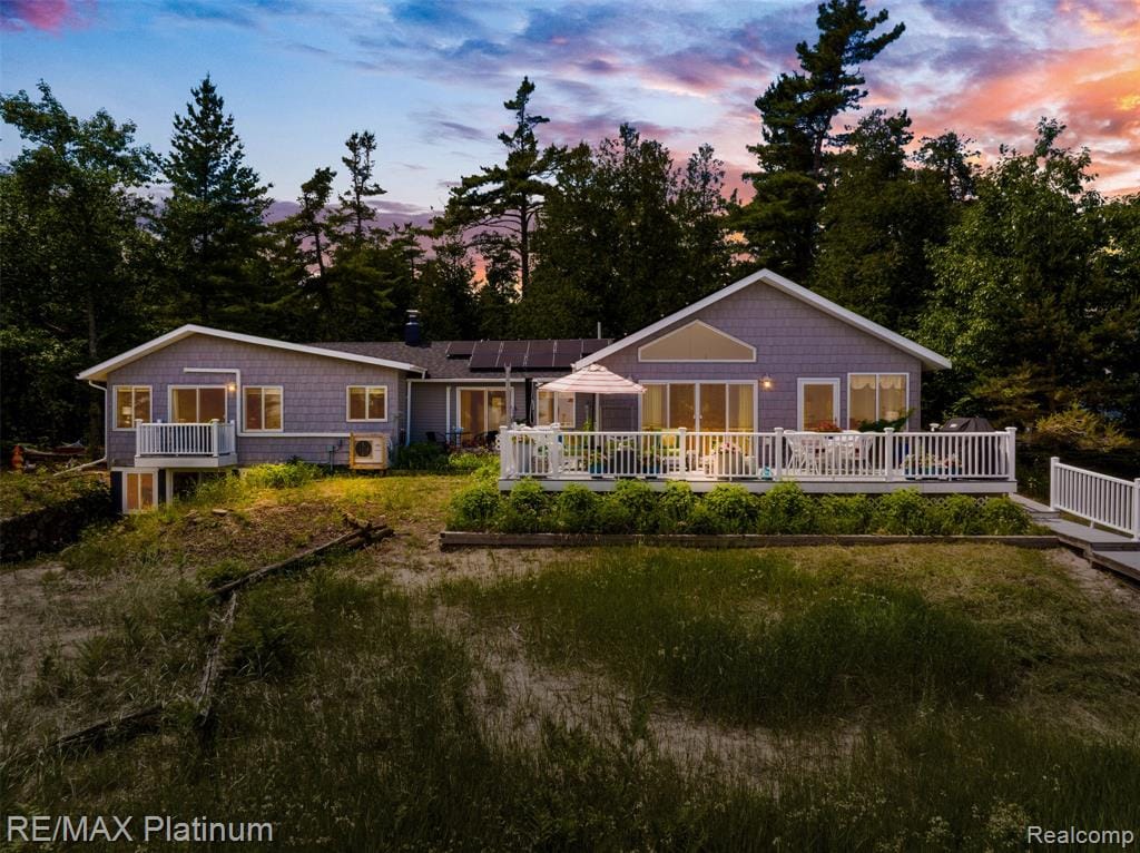 Experience one of Beaver Island’s premier waterfront estates, offering 270 feet of pristine sugar-sand shoreline along the crystal-clear aegean blue waters of Sand Bay on Lake Michigan. Perfectly positioned to capture breathtaking sunrises, this exceptional property blends refined living with the serenity of island life.The main residence features 3 bedrooms and 2 full baths, a thoughtfully renovated chef-inspired kitchen, a sun-filled four-season room, and a custom wine cellar designed for entertaining.  Outdoor living is unmatched with four maintenance-free Trex decks, multiple patios, lush gardens, and inviting gathering spaces that showcase the spectacular waterfront setting. Enhancing the landscape is custom stonework by renowned Beaver Island artisan Dick Burris, adding timeless character and craftsmanship throughout the grounds.  A guest cottage, completed in 2023 offers comfortable accommodations for family and friends. A separate summer house awaits electrical service, creating an outstanding opportunity for additional guest quarters, a studio, or a private retreat. Designed for low-maintenance ownership, this property allows more time to enjoy everything Beaver Island has to offer.  Known for its unspoiled landscapes, crystal-blue waters, and internationally recognized Dark Sky Sanctuary, Beaver Island offers world-class boating, kayaking, fishing, paddle boarding, beachcombing, and some of the finest stargazing in North America. Located within 15 minutes of the airport and downtown St. James on paved roads. Rarely does a property offer this combination of exceptional beachfront, quality craftsmanship, versatile guest accommodations, and unmatched natural beauty. Whether you’re seeking a legacy estate, an island retreat, or an extraordinary waterfront escape this property presents a once-in-a-lifetime opportunity. This remarkable Beaver Island property will not last long!