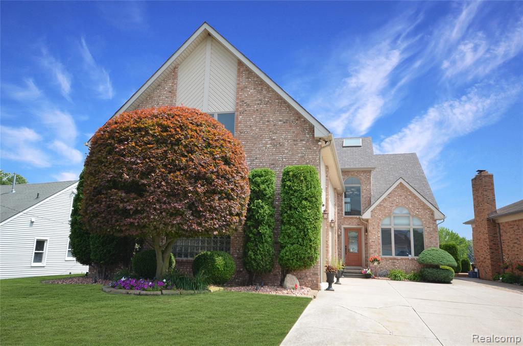 Enjoy waterfront living in this beautifully maintained Harrison Township home, just minutes from Lake St. Clair. Offering 3 bedrooms, 4 full bathrooms, and a spacious 3-car garage, this home combines comfort, functionality, and direct canal access.  A dramatic two-story foyer welcomes you inside, while the kitchen features granite countertops, abundant cabinetry, and plenty of prep space. The spacious primary suite offers cathedral ceilings, a private balcony overlooking the water, and a luxurious ensuite featuring a jetted tub and European steam shower. A large bonus room with a full bathroom and kitchenette provides flexible space for guests, a home office, or recreation. Outside, enjoy a low-maintenance Trex deck, a 20,000-lb boat hoist, and dockage for up to a 35-foot boat and extra deep canal—perfect for enjoying life on the water. Additional highlights include a newer HVAC system and ample storage cabinets in the spacious 3-car garage. Don't miss this opportunity to own a waterfront home in a prime Harrison Township location, just minutes from Lake St. Clair.