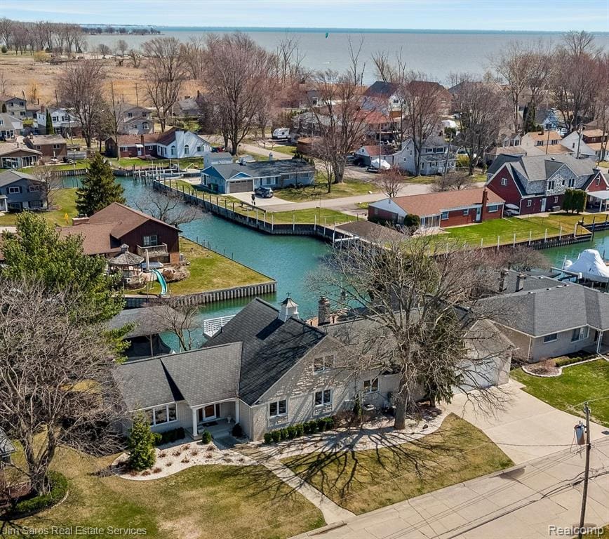 Rare waterfront offering with 120 feet of premium canal frontage on the sought-after Eastside Seaway with quick, direct access to Lake St. Clair. Perfectly positioned on a wide canal at a “T” for easy maneuverability, this custom brick home delivers exceptional indoor and outdoor amenities and a rare 1,300 sqft 5+ car attached garage! Offered at under $225/ square foot with neighboring sales over $300/SF!The large first-floor master suite provides comfort & convenience, while the highly desirable open concept layout flows seamlessly between the large kitchen & family room with fireplace and a light-filled, year-round sunroom overlooking the water. Formal living & dining rooms offer elegant entertaining spaces, complemented by a first-floor laundry & mudroom.Upstairs features 2 spacious bedrooms, a full bath, & versatile bonus room above the garage with separate HVAC—ideal for a home office or studio. The finished basement offers additional living space, including a wet bar, kitchenette, large recreation area, half bath, cedar closet, & dedicated workshop.Additional highlights include a 2017 steel seawall, 2018 custom boathouse w/covered hoist (fits large cruiser), & an additional hoist for personal watercraft. Outdoor spaces include Trex decking, hot tub, hand-laid stone patio & walkway, professional landscaping, & irrigation drawing from the canal.A rare heated & cooled 5+ car garage is a standout, featuring epoxy floors, oil separator drain, built-in storage, sink, multiple overhead doors, and wired for Level 2 EV charging—ideal for car enthusiasts or hobbyists. Updated electrical, plumbing, insulation, Marvin windows, whole-house generator, & smart thermostat.Located in desirable Pointe Rosa with low HOA dues (~$300/year) including canal maintenance & within the L’Anse Creuse School District, this property offers a rare opportunity to enjoy the best of Lake St. Clair living—boating, entertaining, & everyday luxury from your own backyard.