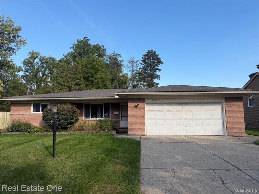 Brick exterior with an attached two-car garage, asphalt shingle roof, and a concrete driveway