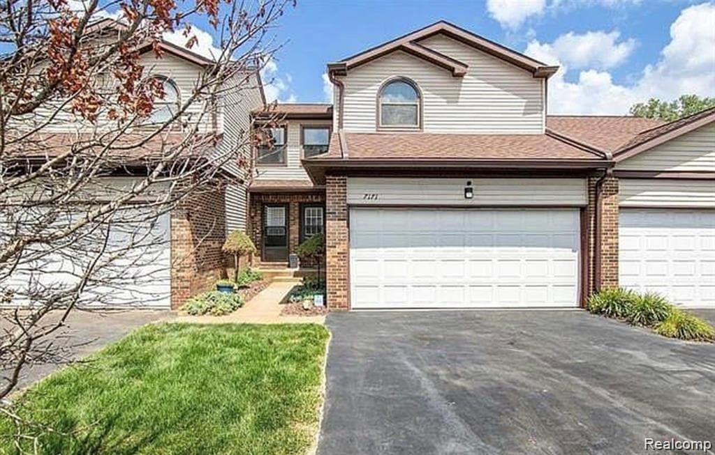 Brick and siding exterior with a two-car garage