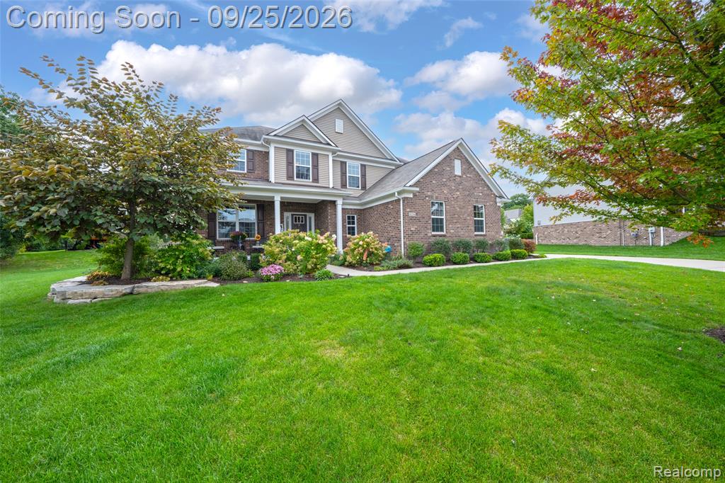 Brick exterior with stone accents and a gabled roofline