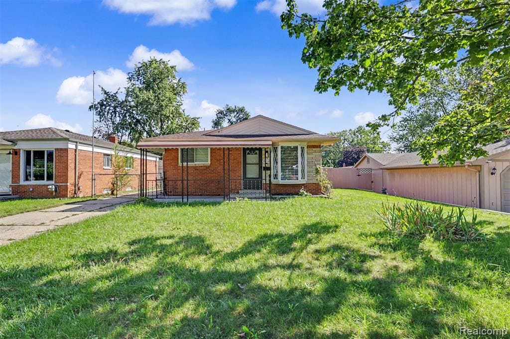 Brick exterior with stone accents, covered front entry, bay window, and a fenced side yard