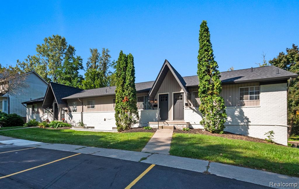 Contemporary multi-unit dwelling featuring a combination of vertical siding and painted brick