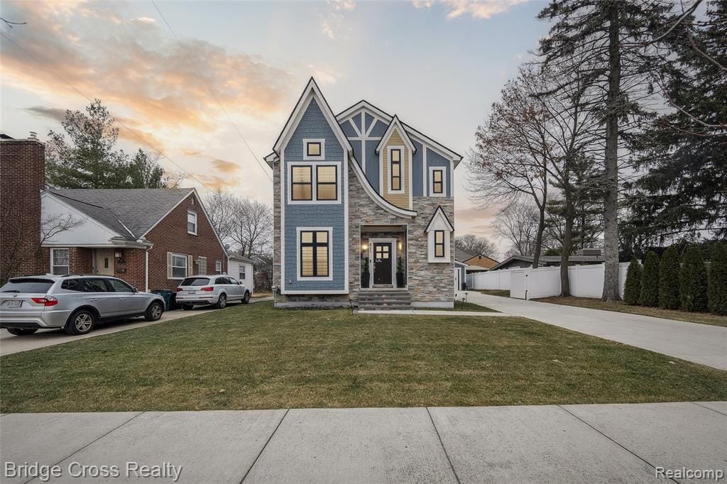 Distinctive multi-story exterior featuring blue siding, stone veneer, and yellow accents