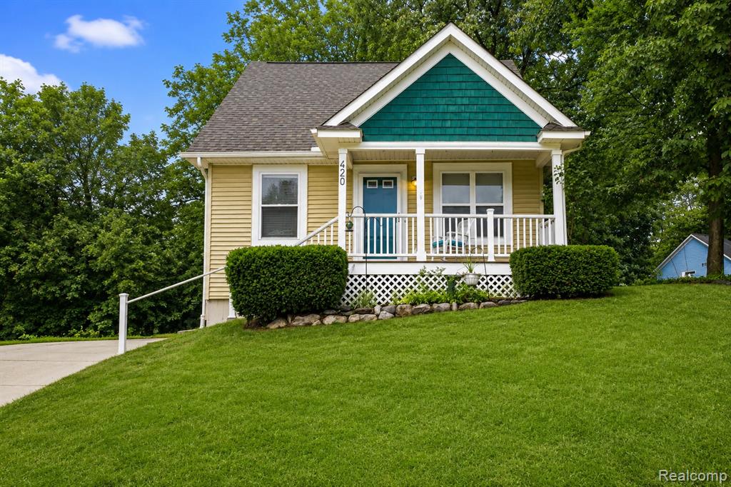 Yellow siding exterior with teal shake siding accent