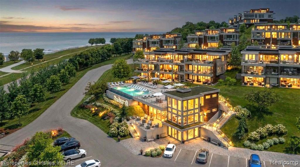 Rising above Little Traverse Bay, The Summit Over Bay Harbor offers a rare opportunity to create a bespoke waterfront residence in one of Northern Michigan’s most prestigious resort settings. Designed for those who value elevated living, privacy, and unforgettable surroundings, each residence captures sweeping water views and dramatic sunsets from multiple levels.This expansive offering features approximately 5,586 square feet of interior living space, complemented by a 1,139 square foot rooftop terrace designed for entertaining, relaxation, and evening gatherings overlooking Lake Michigan. An additional 720 square feet of unfinished lower-level space provides flexibility for storage or future customization, bringing the total square footage to approximately 7,445 square feet. Floor-to-ceiling windows flood the interiors with natural light and frame the bay as a living work of art. The open main living level is ideal for hosting, anchored by a gourmet kitchen with premium appliances, generous island, fireplace, wet bar, and seamless indoor-outdoor flow.The primary suite is a serene retreat with panoramic water views, private patio access, a spacious walk-in closet, and spa-inspired bath. Multiple en-suite bedrooms, each with private outdoor access, provide exceptional comfort and privacy for family and guests. A detached guest house and four-car garage further enhance the residence, while elevator access connects each level with ease.Residences at The Summit Over Bay Harbor are offered as custom build opportunities, allowing buyers to select architectural details, interior finishes, and premium upgrades tailored to their lifestyle.Located across from The Cliffs at Bay Harbor and minutes from Petoskey, Charlevoix, Boyne City, and Harbor Springs, this is Northern Michigan luxury living at its finest.