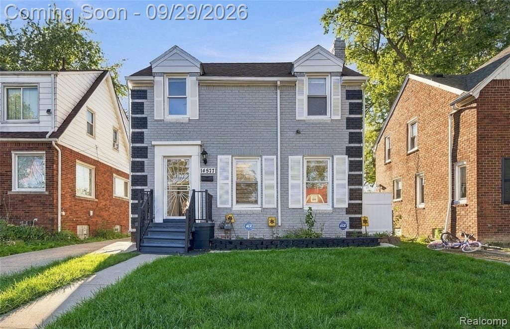 Gray brick exterior with white trim and shutters