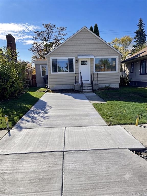 Exterior features light-colored siding with shingle accents and a prominent front entry