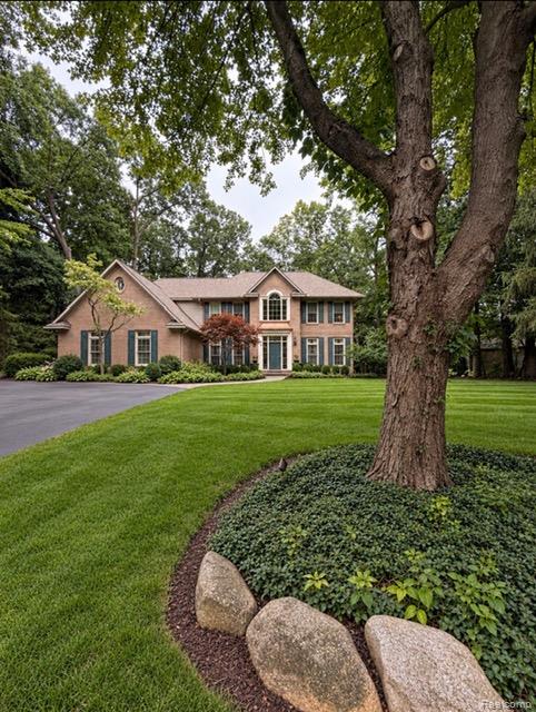 Brick exterior with a gabled roof and arched window above the entry