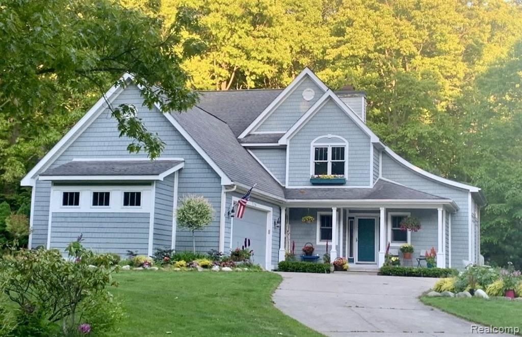 Welcome to this beautiful Cape Cod style two-story home featuring timeless, gray shingles with crisp, white trim, located on a desirable quiet street just a short one block walk away from Lake, Michigan, Grand Haven, top rated schools, parks, and scenic bike paths. With four bed rooms, 3.5 baths, and finished basement, this home offers a fantastic floor plan perfect for both every day living in entertaining. The spacious main floor centers around a stunning floor to ceiling, stone, wood-burning fireplace, ( gas plumbed) visible from nearly every room on the main level. The open concept, layout features a formal dining room, breakfast and a large kitchen with a tiled island. A bright sunroom with soaring 12 foot ceilings, bring in natural light year-round, while a dedicated home office with a cozy setting sitting area provides the perfect work from home retreat. Upstairs, you'll find three generously sized bedrooms, including a serene master suite with an attached master bath. The finished basement adds valuable living space with a daylight bedroom, full bath, and kitchenette, ideal for guests, in-laws or a teen suite. The attach to and a half stalled garage includes a bump out for extra storage or a workshop area. Outdoors, enjoy a private backyard that backs up to acres of undeveloped, woods, offering peace, privacy, and a natural setting. Don't miss this opportunity to own a move in ready home in one of the most sought after neighborhoods on the Lakeshore.