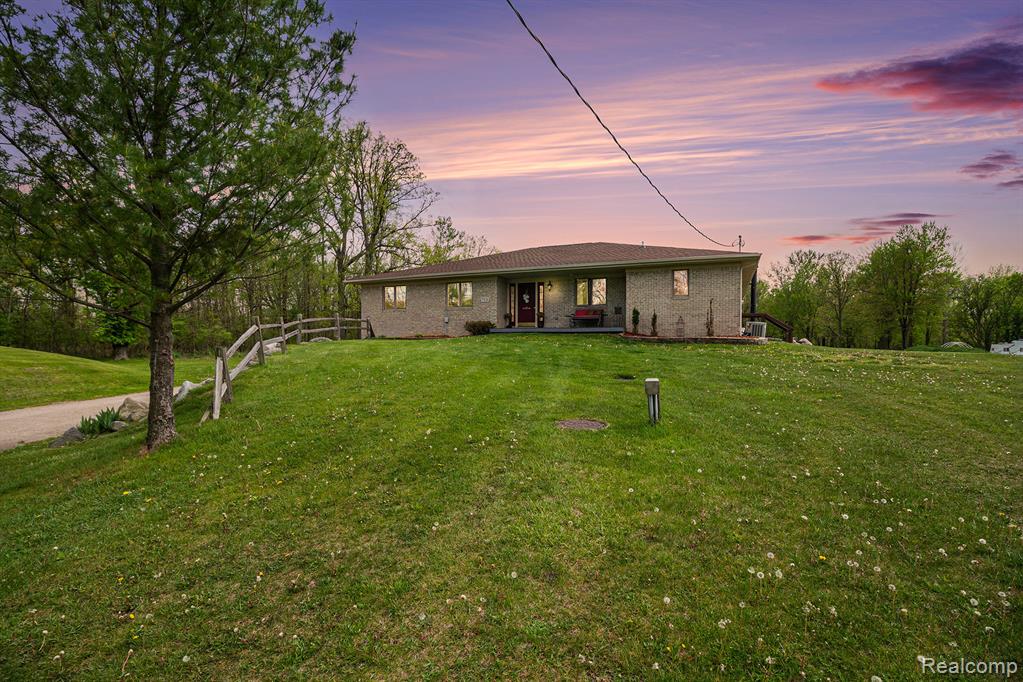 Discover endless possibilities w/this incredible private retreat situated on 10 stunning acres.  If you’re dreaming of a hobby farm, equestrian property, private hunting retreat, outdoor recreation destination, home-based business, auto repair/paint, family compound, or simply a peaceful country escape, this unique property offers the space & setting to bring your vision to life. The grounds feature 2 stocked ponds loaded with fish. Groomed trails wind through the addtl wooded acreage, creating the perfect environment for nature walks, ATV riding, horseback riding, hunting or wildlife observation.  Beautifully maintained home offers comfortable living space designed for both everyday living & entertaining. Spacious kitchen is a cook’s delight, featuring Jenn Air cooktop, wall ovens, large pantry, abundant counter space, and butler’s area between Kitchen & DR.  The primary suite provides a private retreat w/ deck access through doorwall, a large closet, vanity area, jetted tub, & walk-in shower.  Massive mudrm/laundry rm w/a dog-washing station & full bath.  Finished W/O LL expands your living space w/rec rm, BR, office, storage room, and full bath with direct outdoor access—ideal for guests, multi-generational living, hobbies, or working from home.  Major improvements and features include Anderson windows and doors, fiber optic internet, dual heating systems featuring a Hotblast wood-burning furnace plus forced air furnace, newer water heater, roof approximately five years old.  Car enthusiasts, hobbyists, contractors, entrepreneurs will appreciate the impressive outbuilding equipped with a heavy duty hoist/lift and paint booth.  Expansive grounds provide ample room for gardens, livestock, recreational activities or additional outbuildings.  A deck replacement is needed & has been thoughtfully reflected in the asking price. For those seeking even more room to roam, an additional 18 adjoining acres are available, creating an extraordinary 28-acre estate.
