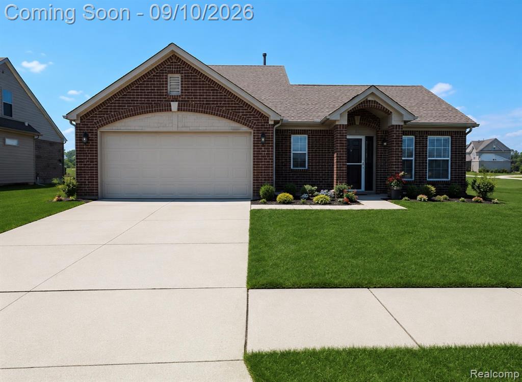 Brick exterior with a gabled roof and attached garage