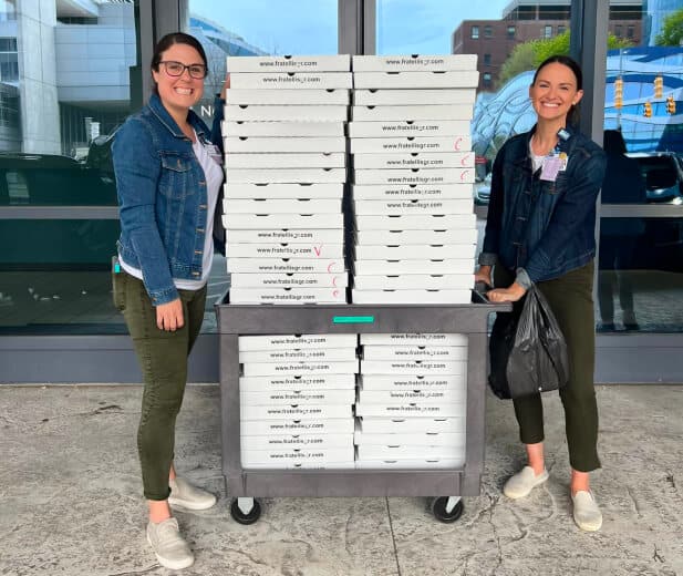employees holding pizza boxes (1)