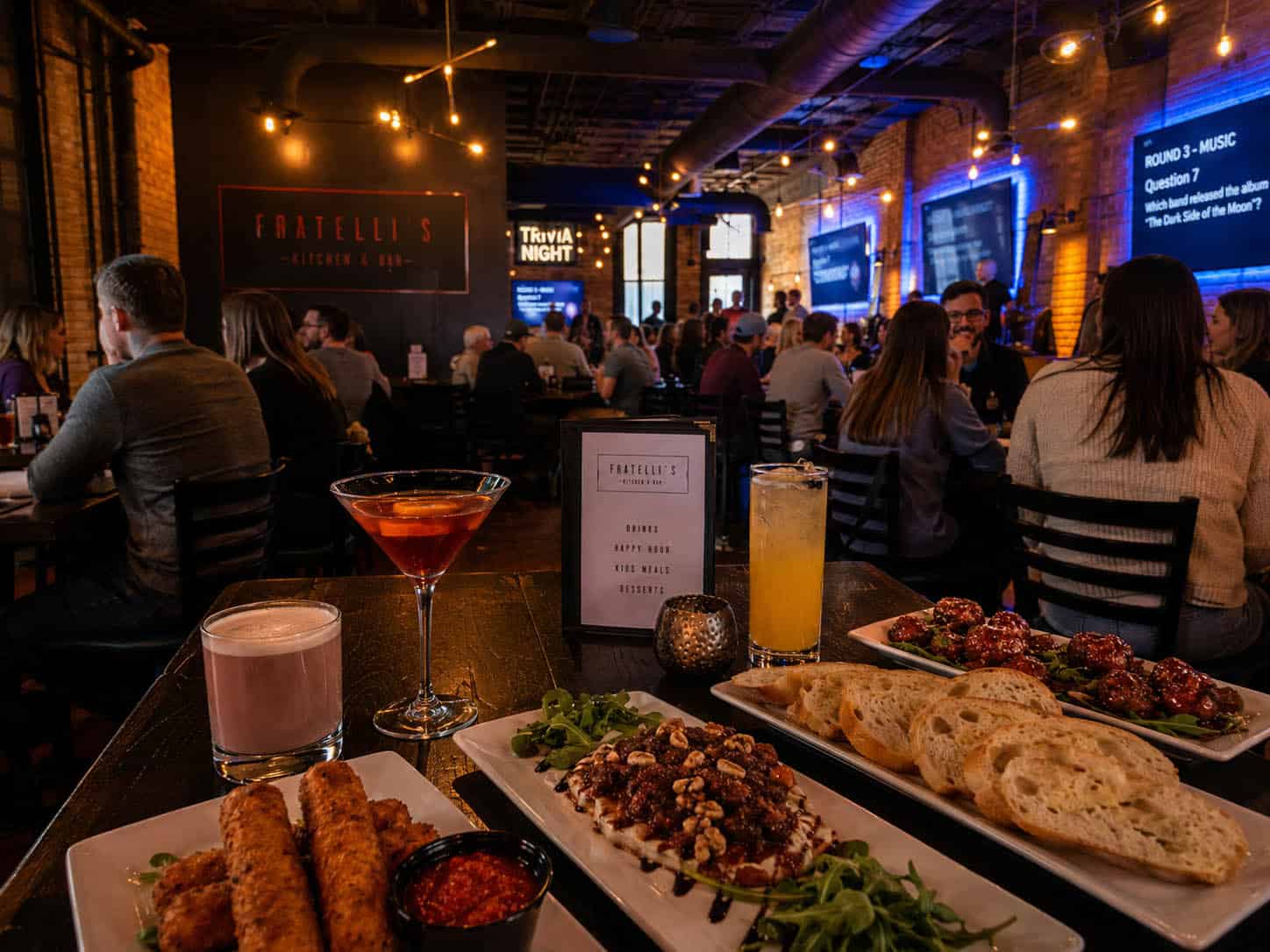 Cozy Italian restaurant with patrons enjoying food and drinks.