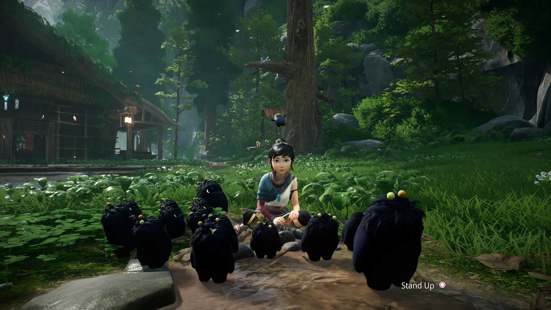 Kena surrounded by cute forest spirits.