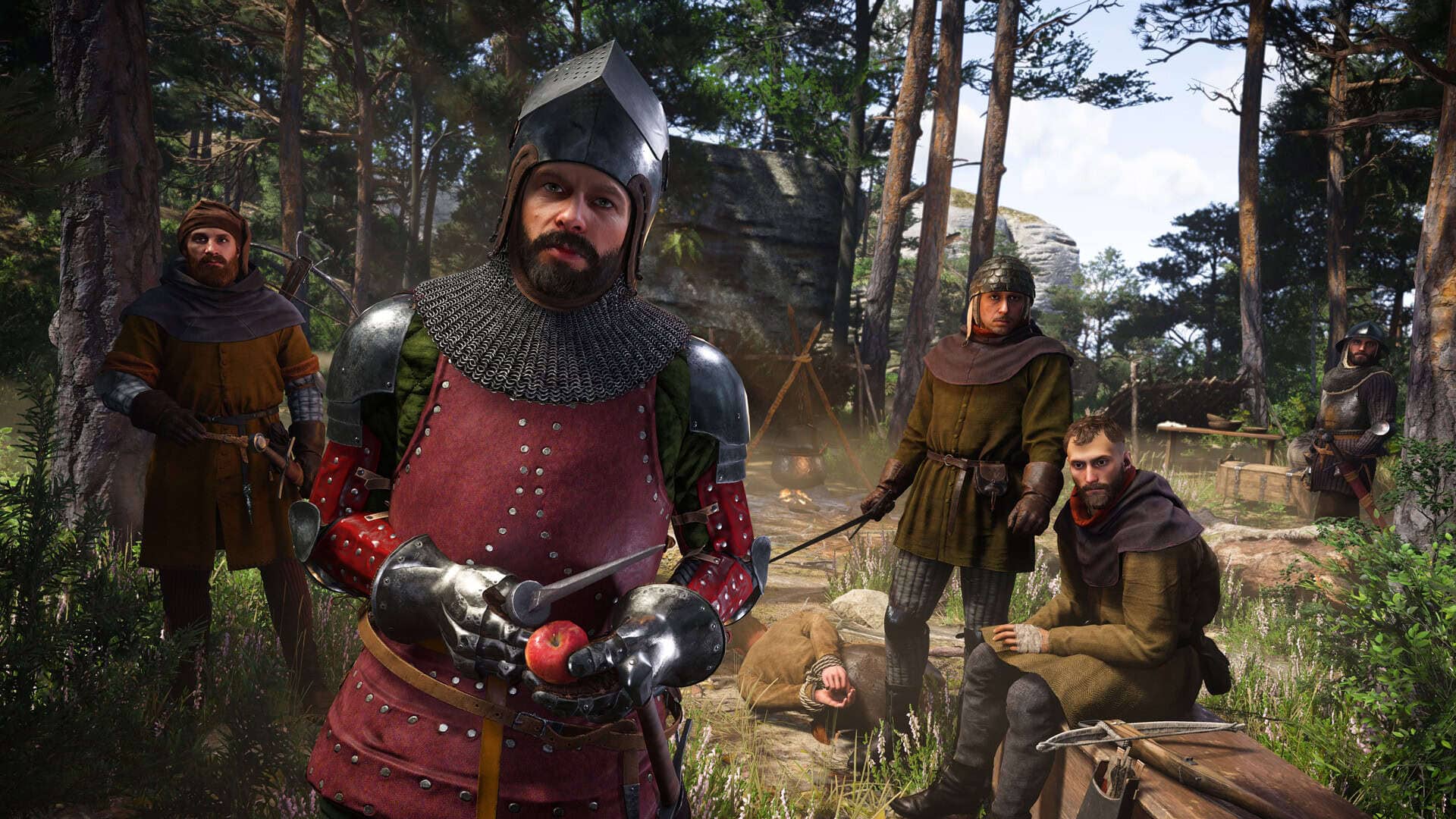Kingdom Come Deliverance II screenshot showing a bunch of well-dressed soldiers stood in a camp, with a person tied up on the floor.