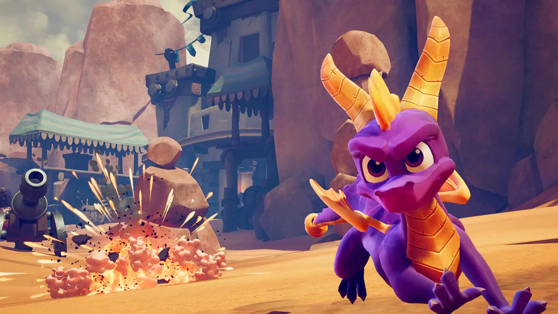 Spyro Reignited Trilogy screenshot showing Spyro running away from a cannon in a desert-like land.
