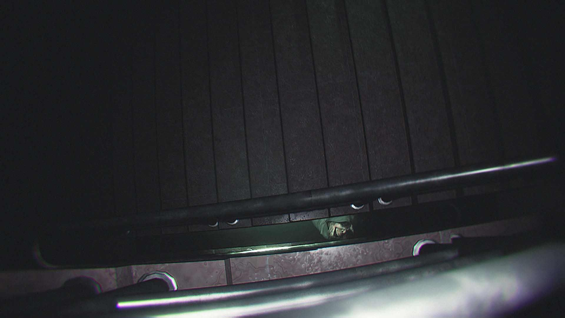 The stalker's face seen down a staircase in Dread Neighbor.