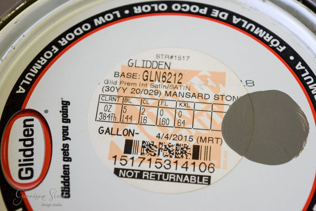 Close-up of a Glidden paint can lid with label details—perfect for your next IKEA desk hack. Includes base: GLN6212, color: Mansard Stone, and size: 1 gallon. Marked "Not Returnable.