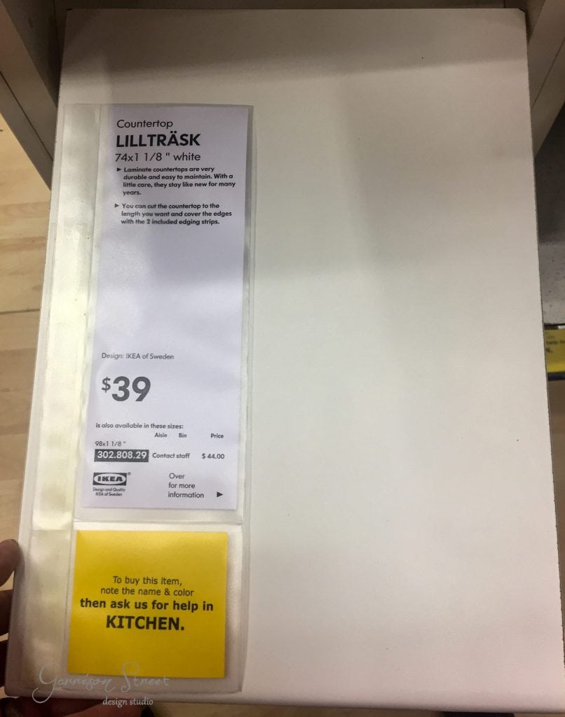 A white IKEA countertop labeled "LILLTRÄSK," priced at $39, dimensions 74x1 1/8 inches, perfect for an IKEA desk hack. A note suggests seeking assistance in the kitchen section to purchase.