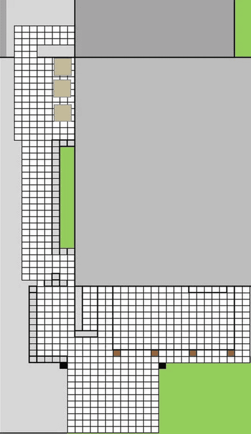 A top-down schematic of a building layout featuring a gray structure with a surrounding grid-patterned walkway, small green lawn areas, and four brown squares indicating possible furniture or features.