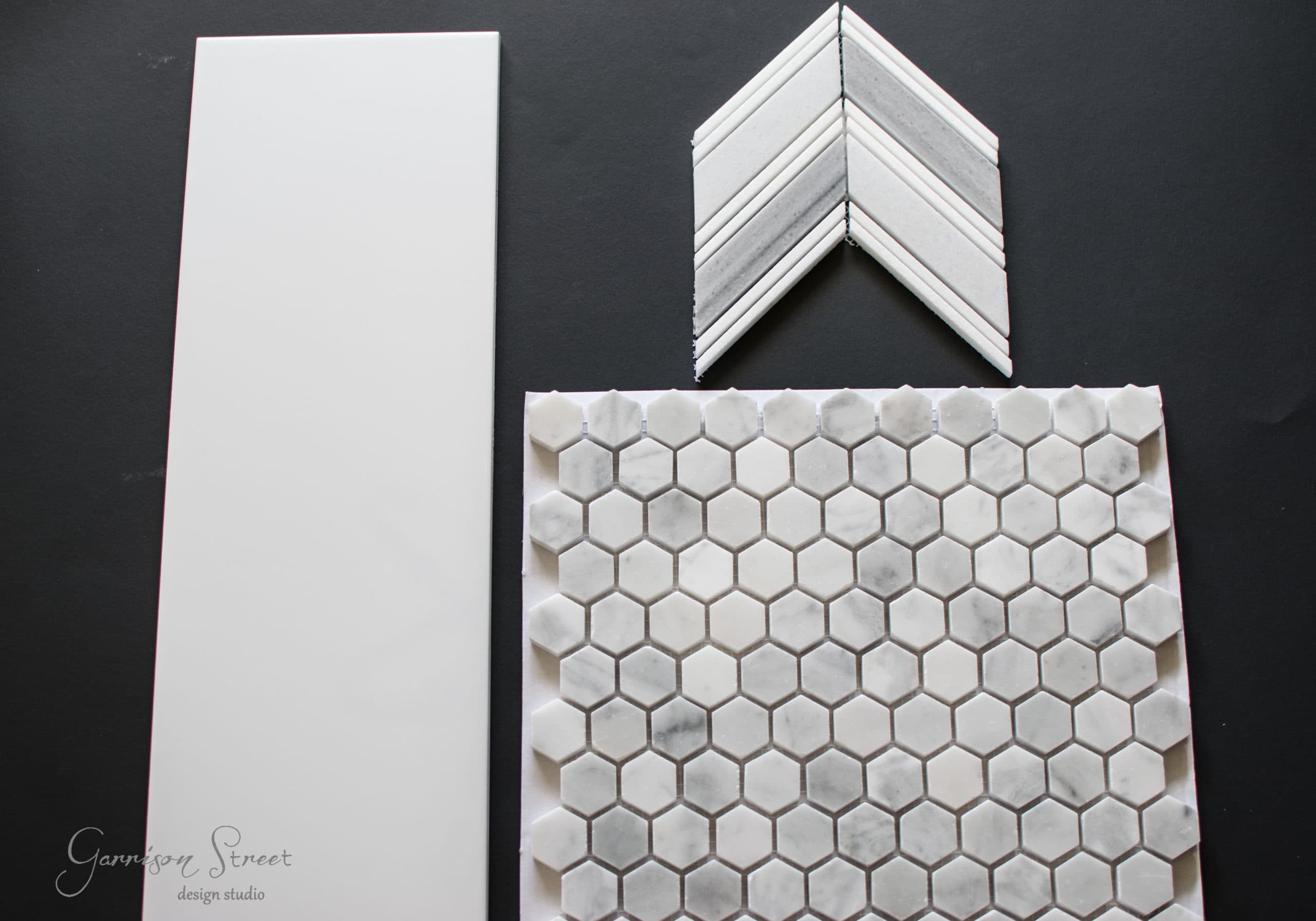 A sample layout featuring three different tile designs on a dark background: a large plain white tile, a chevron-patterned tile, and a sheet of hexagonal marble tiles.