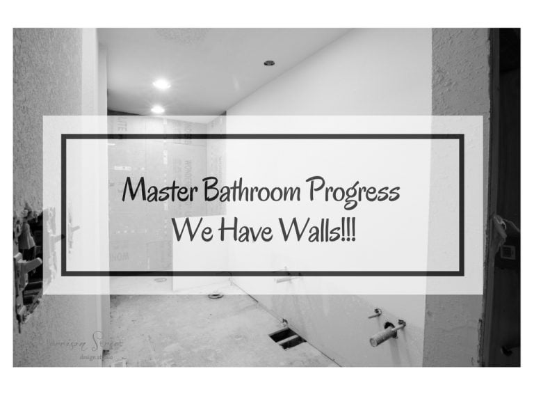 A black and white photo shows a partially constructed master bathroom with unfinished walls and plumbing fixtures visible. Text overlay reads "Master Bathroom Progress We Have Walls!!!.