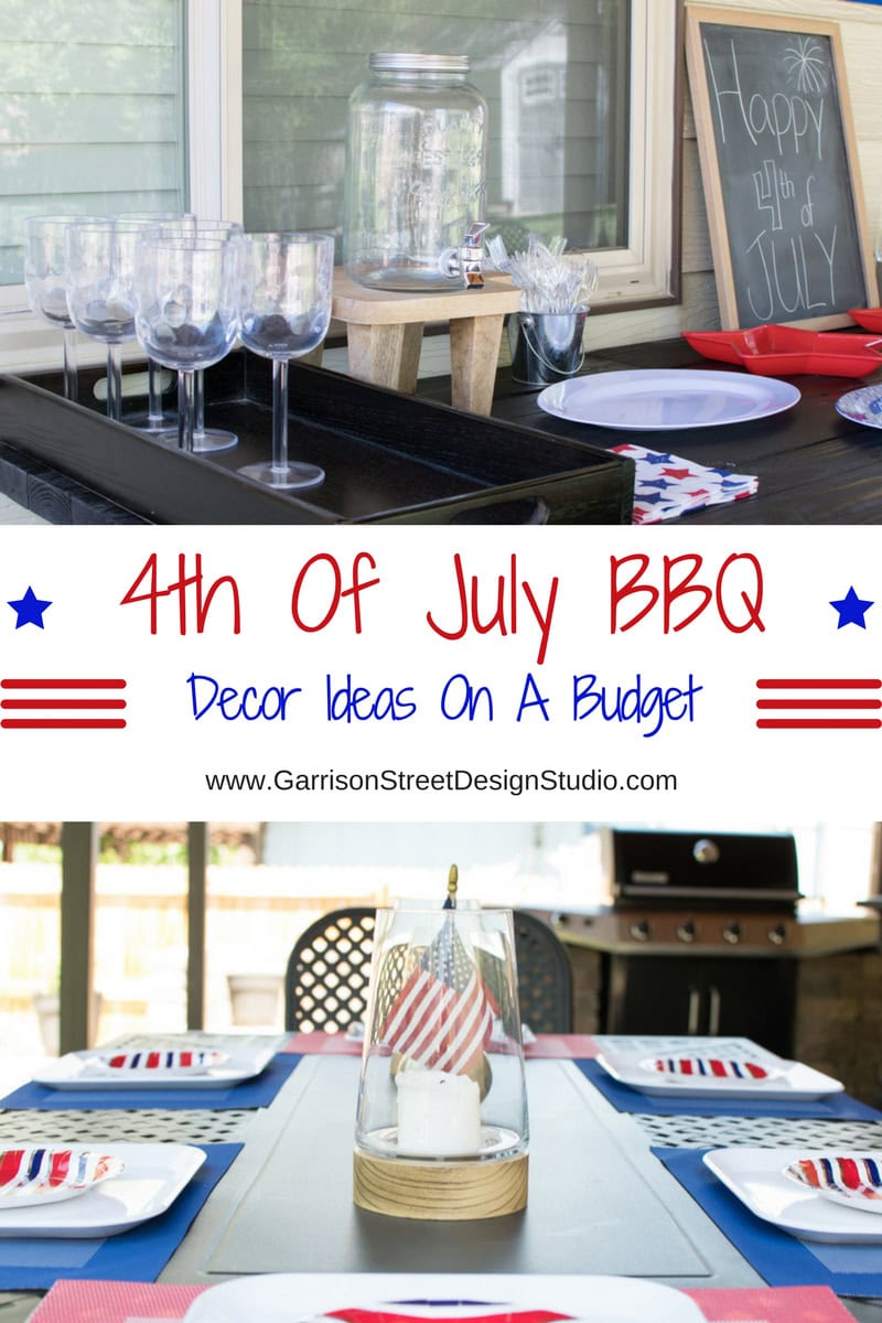 Festive 4th of July BBQ setup with red, white, and blue decorations. Features a jar with flags, patriotic plates, and a drinks station. A chalkboard in the background reads "Happy 4th of July.