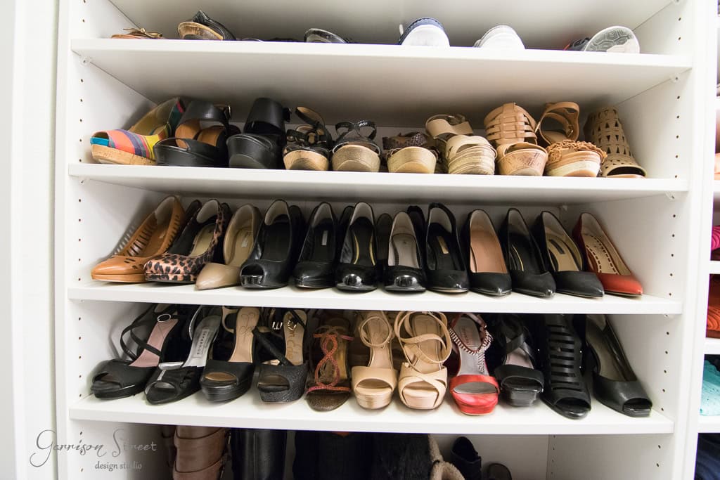 A neatly organized shelf filled with various women's shoes, including high heels, sandals, and wedges in different colors and styles. The shoes are arranged in rows on four shelves inside a white IKEA closet unit.