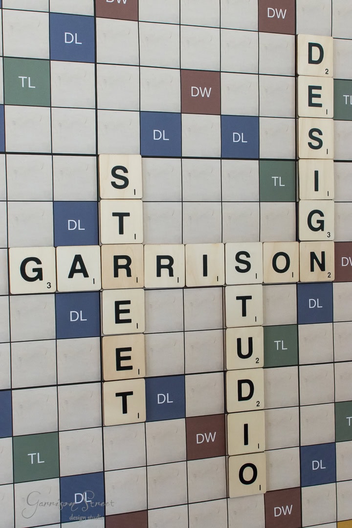 Scrabble board displaying the words "Garrison Street Design Studio" using letter tiles. The tiles are arranged across premium squares, offering double and triple word and letter scores.