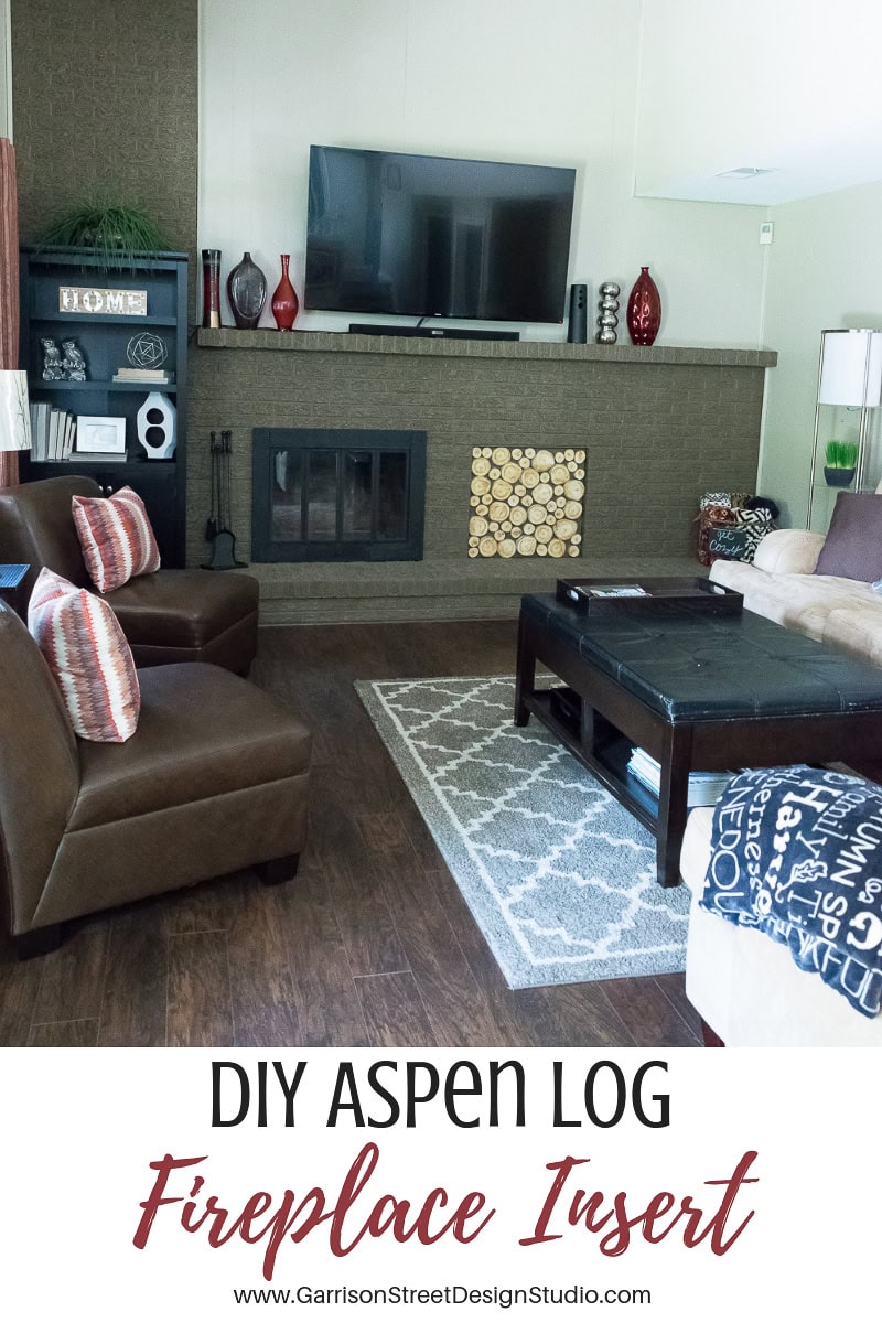 Living room with a large fireplace showcasing an aspen log insert. The space is adorned with brown leather chairs, a patterned rug, and decorative shelves. Text at the bottom reads "DIY Aspen Log Fireplace Insert" with a website link to Garrison Street Design Studio.