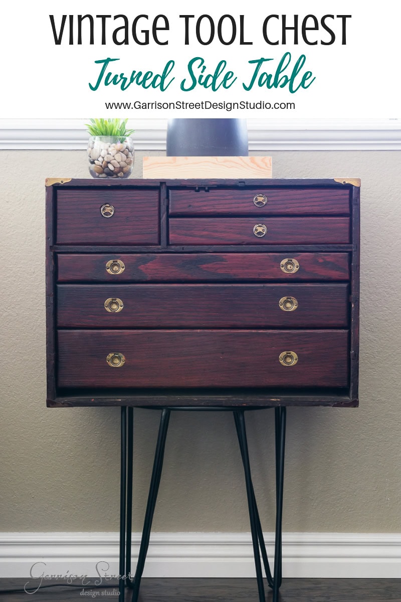 Vintage tool chest repurposed as a side table features wooden drawers and black hairpin legs. A small plant in a glass pot sits on top, enhancing its rustic charm. The text above reads, "Vintage Tool Chest Turned Side Table.
